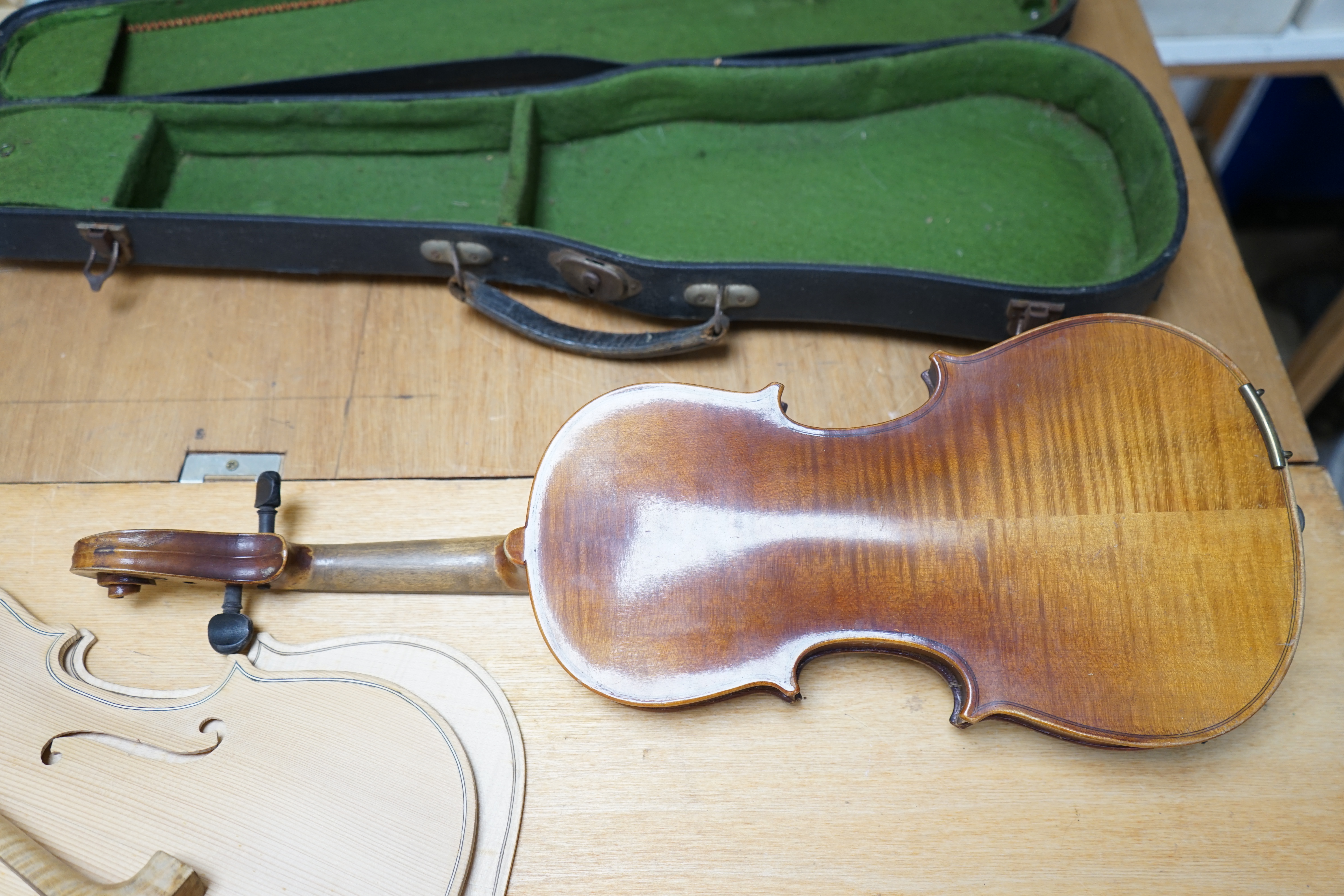 Early 20th century ¾ size violin, unlabelled, cased, together with a violin table, back and scroll. Condition - fair